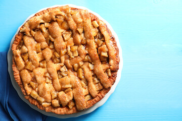 Homemade apple pie on light blue wooden table, top view. Space for text
