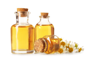 Bottles of essential oil and chamomile flowers isolated on white