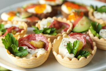 Many different tasty canapes on stand, closeup