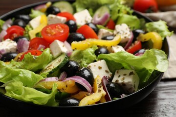 Delicious fresh Greek salad on table, closeup
