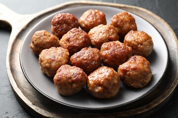 Tasty cooked meatballs on grey table, closeup