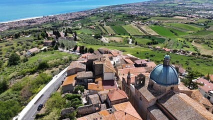 Aerial drone view of Montepagano hill with buildings in the province of Teramo in Italy and the Adriatic Sea.
