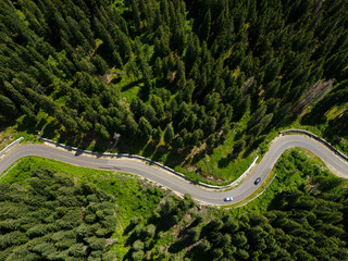 Winding road trough dense pine forest. Aerial drone view, top down © Rafaila Gheorghita