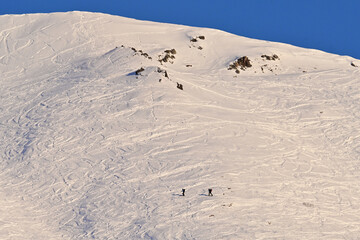 Outdoor enthusiasts enjoy a winter day of backcountry skiing  in Alaska's Talkeetna Range.