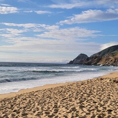beach at dusk with mountains 