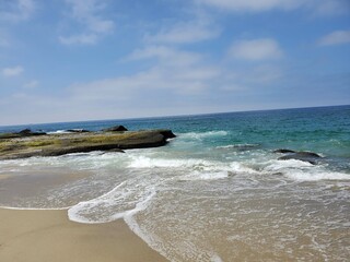 Crystal clear ocean water crashing along the rocks