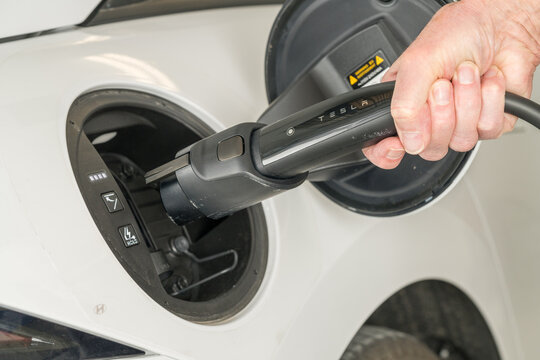 Georgetown, TX - 4 January 2025: Level 2 charging with J1772 adaptor on Tesla charging cable to recharge modern electric car battery
