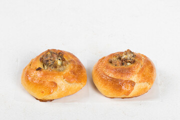 Two Small Open pie filled with fish, eggs and onions. White background. Close up