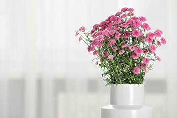 Beautiful pink flowers in vase at home, space for text