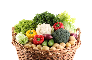Different fresh vegetables in wicker basket isolated on white