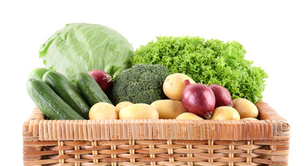 Different ripe vegetables in wicker box isolated on white