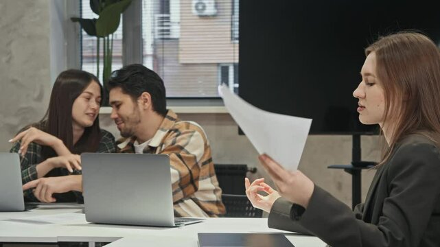 Couple of office workers who are in love flirt with each other at work, which is unprofessional and upsets colleague who demands that they get back to work.