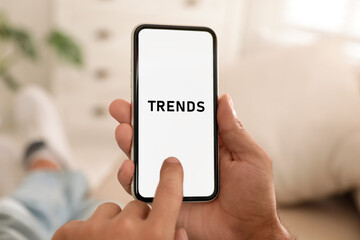 New trends. Man using mobile phone indoors, closeup