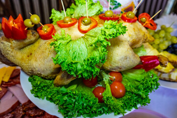 Celebratory dish with decorated roasted chicken and fresh vegetables