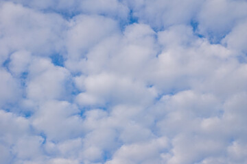 Fluffy white clouds in a bright blue sky during daytime