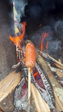 Experience the magic of the outdoors as sausages roast on sharpened sticks over a lively fire. A traditional way to enjoy a hearty meal surrounded by nature.