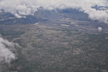 Fototapeta premium Iceland from airplane through clouds. Aerial scenic view of Iceland landscape. Travel vacation concept. Europe.