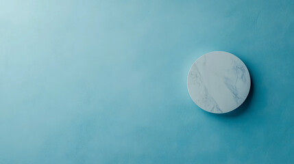 Minimalist marble circle on textured blue wall background for modern design