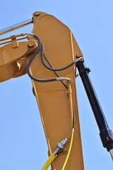 The yellow crane is a manipulator with a hydraulic cylinder.