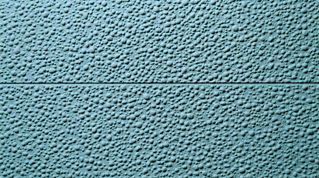 Textured blue surface, close-up view of a pebble-dash wall or similar material. Ideal for backgrounds, design, and architectural projects.