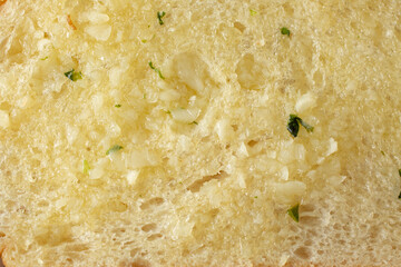A top down view of a slice of garlic bread, as a background.