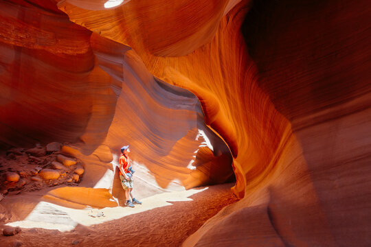 Man exploring a slot canyon, Arizona, United States