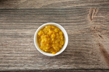 A top down view of a condiment cup of kik alicha.