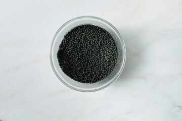 A top down view of a jar of hing vati.