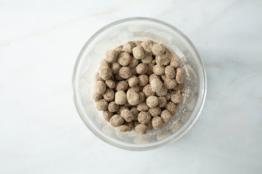 A top down view of a glass jar of churna vati supplements.