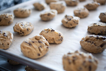 A view of raw cookie dough balls on a baking sheet.