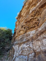 Cliff face on North Durras Beach New South Wales, Australia. Surrounded by a sandy beach. Beautiful blue sky