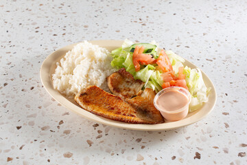 A view of a fried tilapia entree.