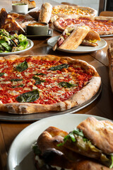 A view of several Italian entrees on a restaurant table.