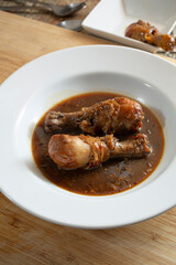 A view of slow cooker chicken drumsticks in a plate.