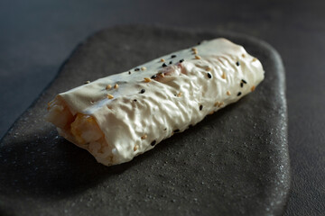 A closeup view of a shrimp hand roll.