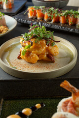 A view of a spicy mayo shrimp tempura appetizer, among other Japanese entrees.