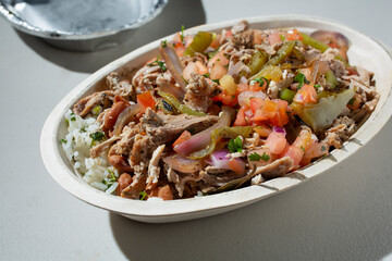 A view of a restaurant style carnitas burrito bowl.