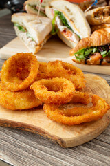 A view of a plate of onion rings, among other entrees.