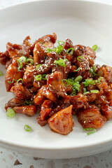 A view of a bowl of teriyaki chicken.