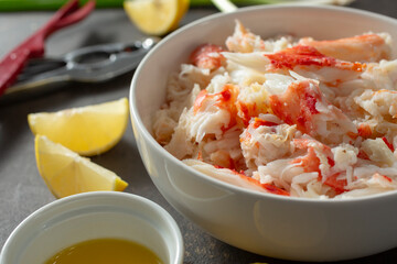 A view of a bowl full of king crab leg meat.