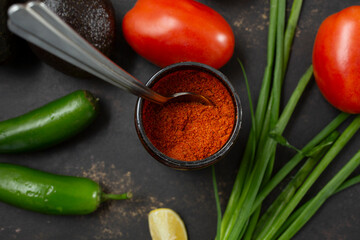 A top down view of a spoon inside of a tomato chicken bouillon container.