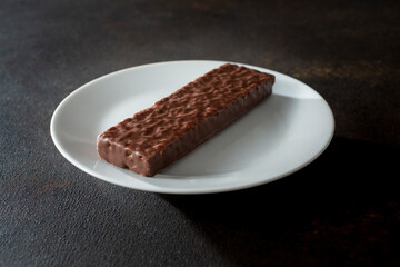 A view of a chocolate candy bar, on a plate.