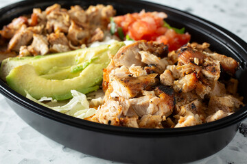 A closeup view of a Mexican restaurant style chicken bowl.
