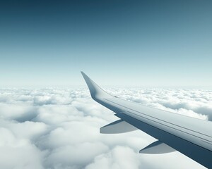 Fototapeta premium A serene view from an airplane wing above fluffy clouds, capturing the beauty of flight and the vastness of the sky.