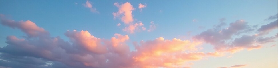 Fototapeta premium Evening sky is painted with hues of blue and white, dotted with wispy orange clouds, evening, wispy