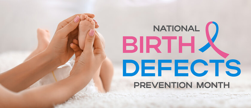 Mother massaging her baby's foot in bedroom, closeup