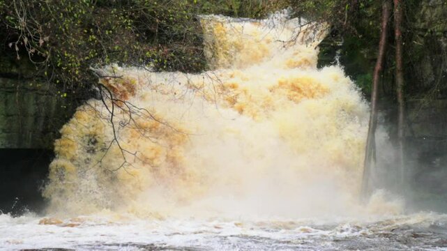 Close of of slow motion waterfall in full spate