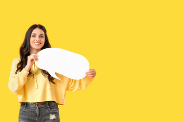 Young woman with blank speech bubble on yellow background