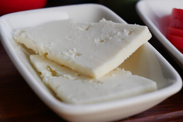 Delicious Soft Cheese Blocks Arranged on a Plate with Fresh Garnish