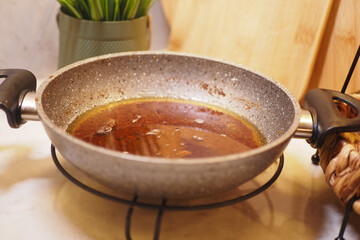 used cooking oil in frying pan.